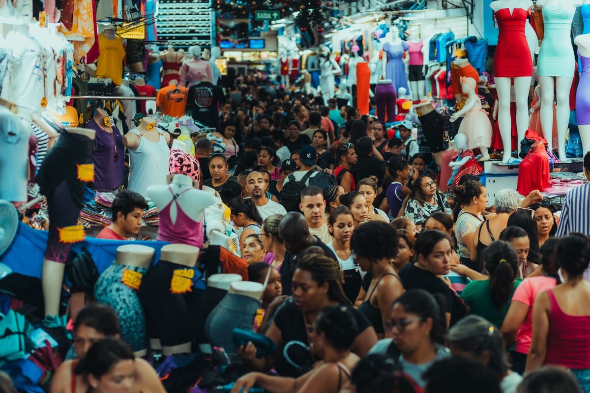 Visitors walking a busy trade-show aisle