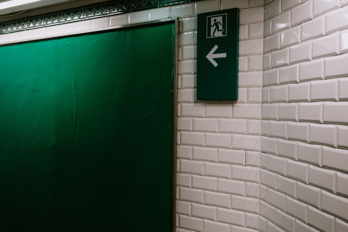 Directional arrow signs along a corridor