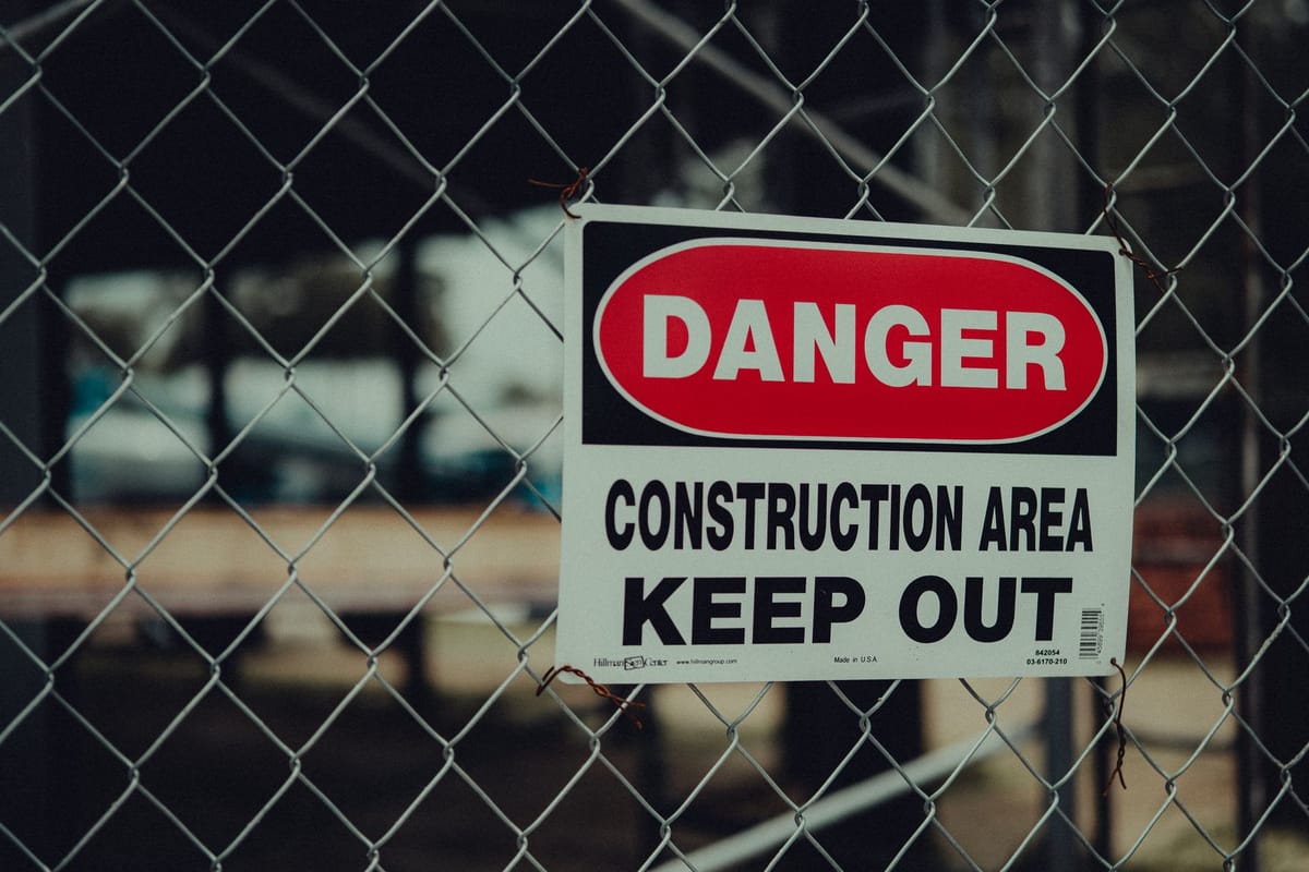 A mesh banner on a construction-site fence