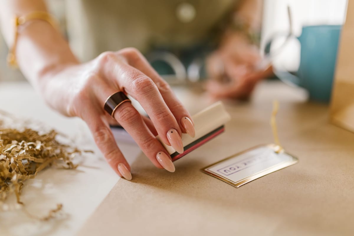 A small business stamping its logo on packaging