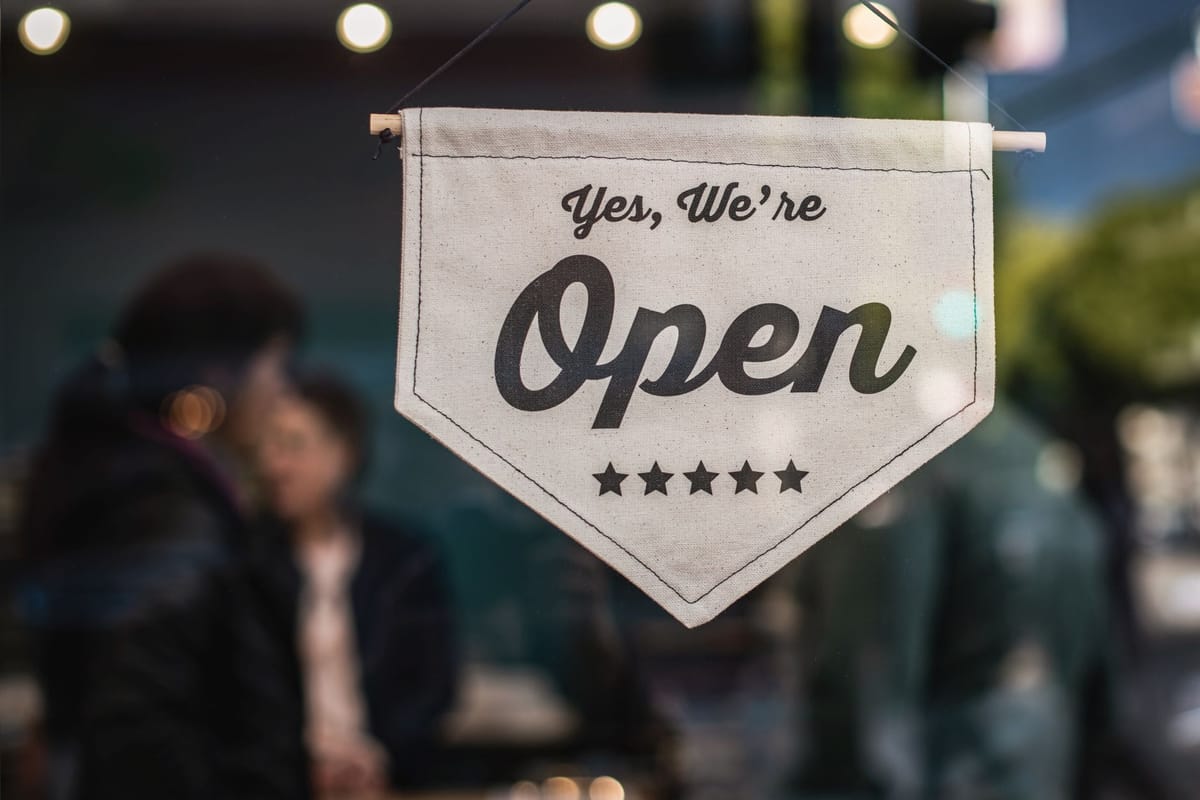 A grand-opening banner on a new shopfront